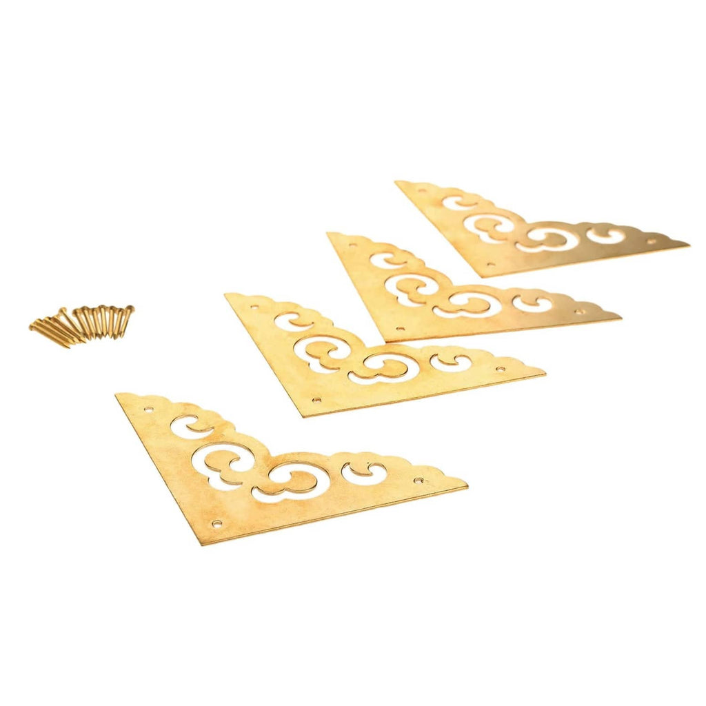 Brass table corner bracket set with ornate scroll cutouts and mounting holes, flat corners