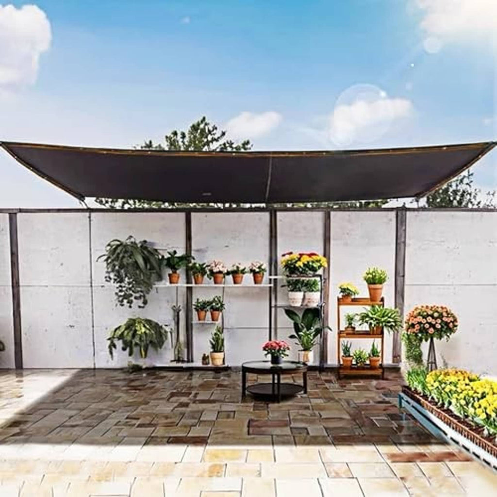 Outdoor shade cover stretched over patio, dark panel with grommet corners
