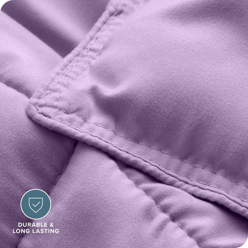 Lavender comforter fabric close-up with stitched seam detail