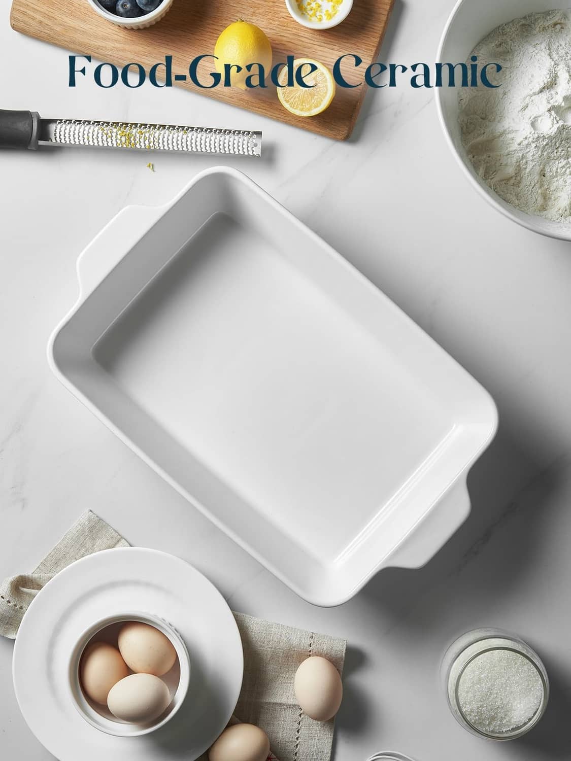 White ceramic deep baking dish, rectangular shape with ribbed exterior.