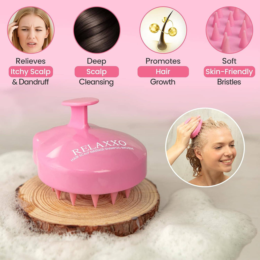 Pink scalp massager brush with soft silicone bristles shown in use on hair