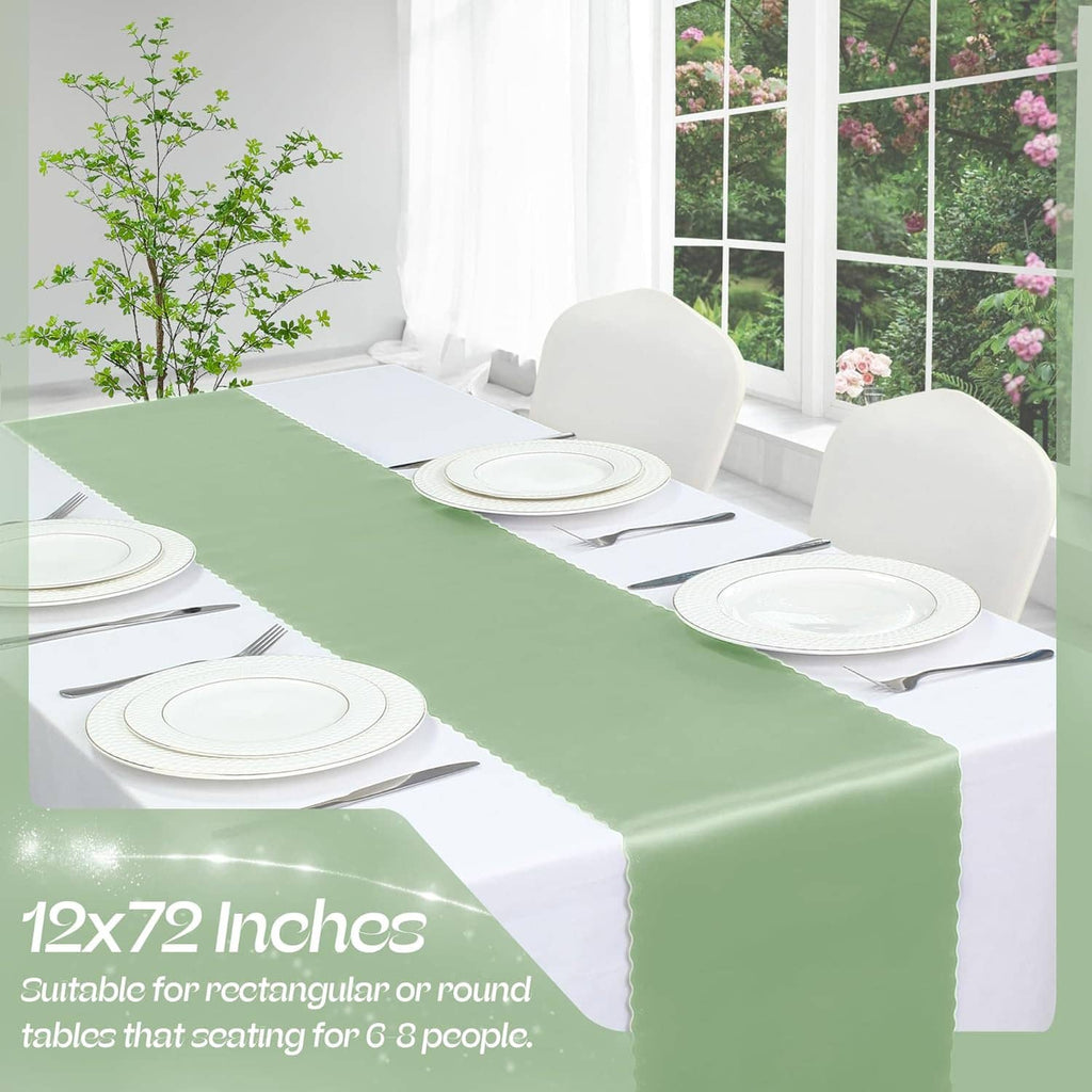 Sage green satin table runner centered on a table with white dinnerware