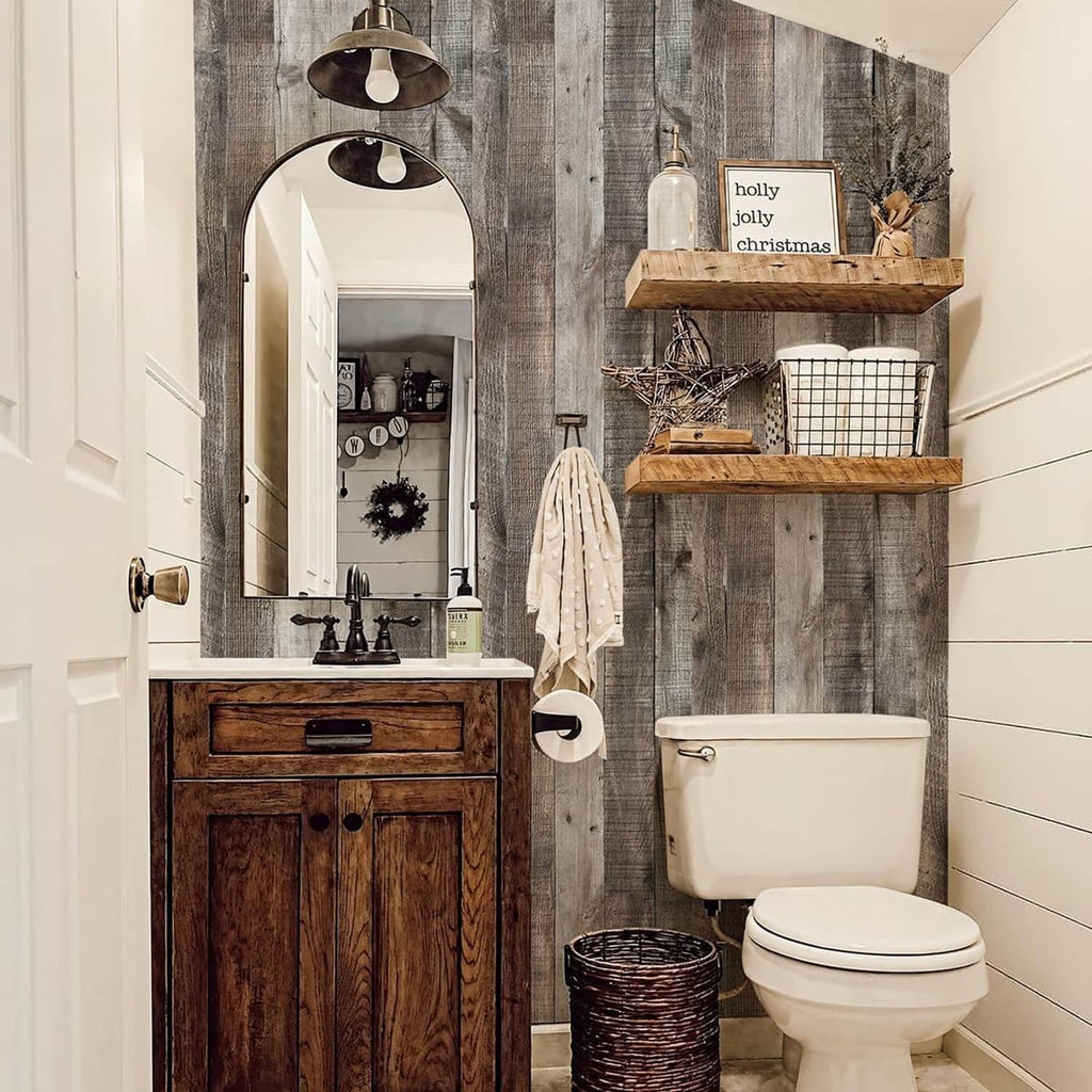 Gray wood-plank peel-and-stick wallpaper covering bathroom wall panels