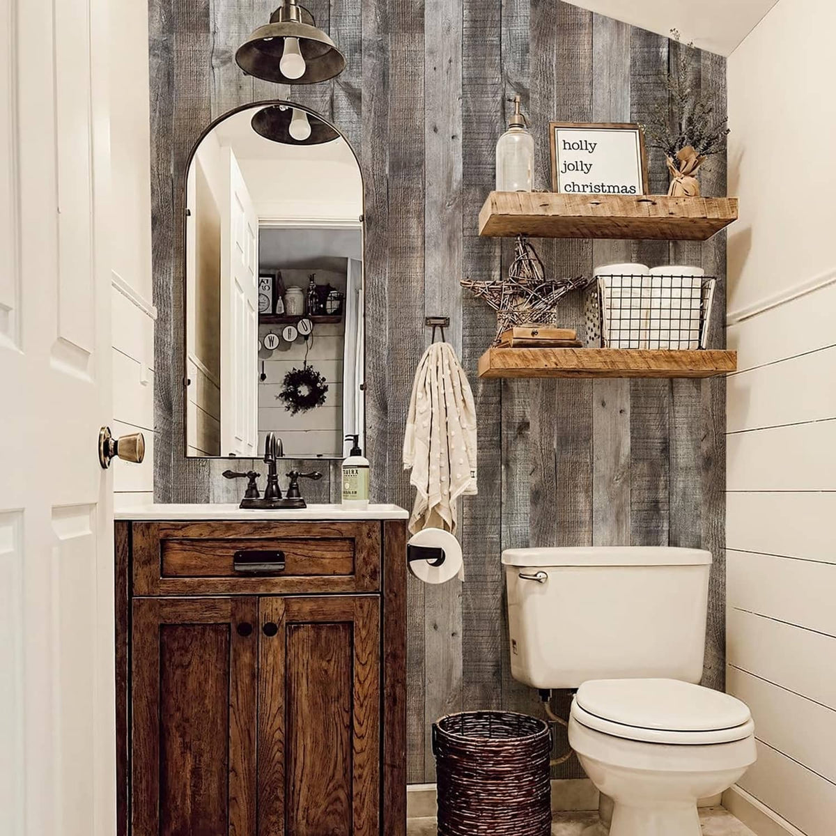 Gray wood-plank peel-and-stick wallpaper covering bathroom wall panels