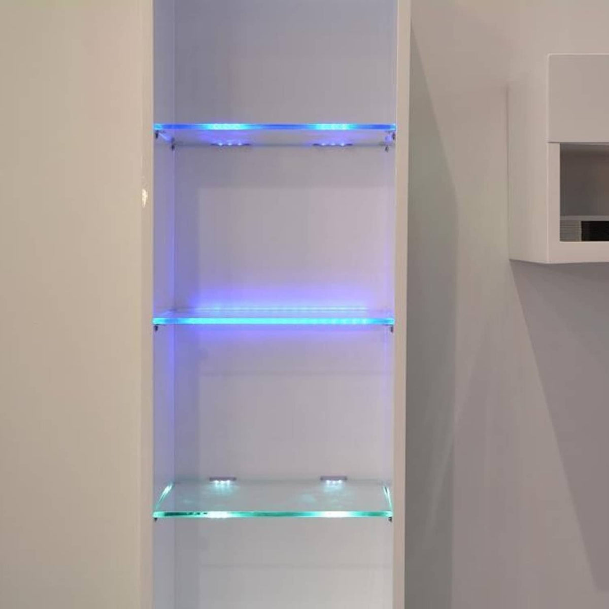 LED under-shelf lights casting blue and purple glow inside glass display shelf