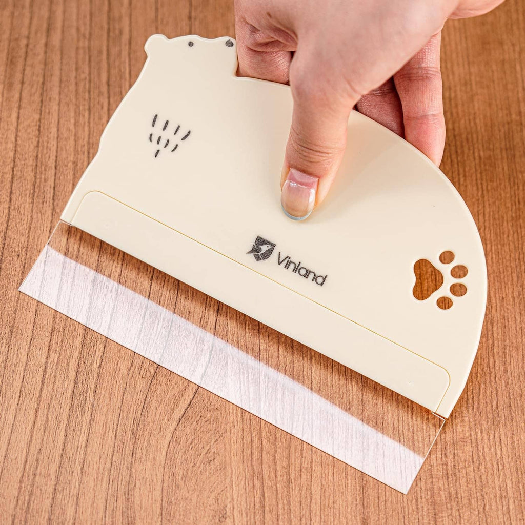 Cream bear-shaped cake scraper with straight edge for smoothing frosting