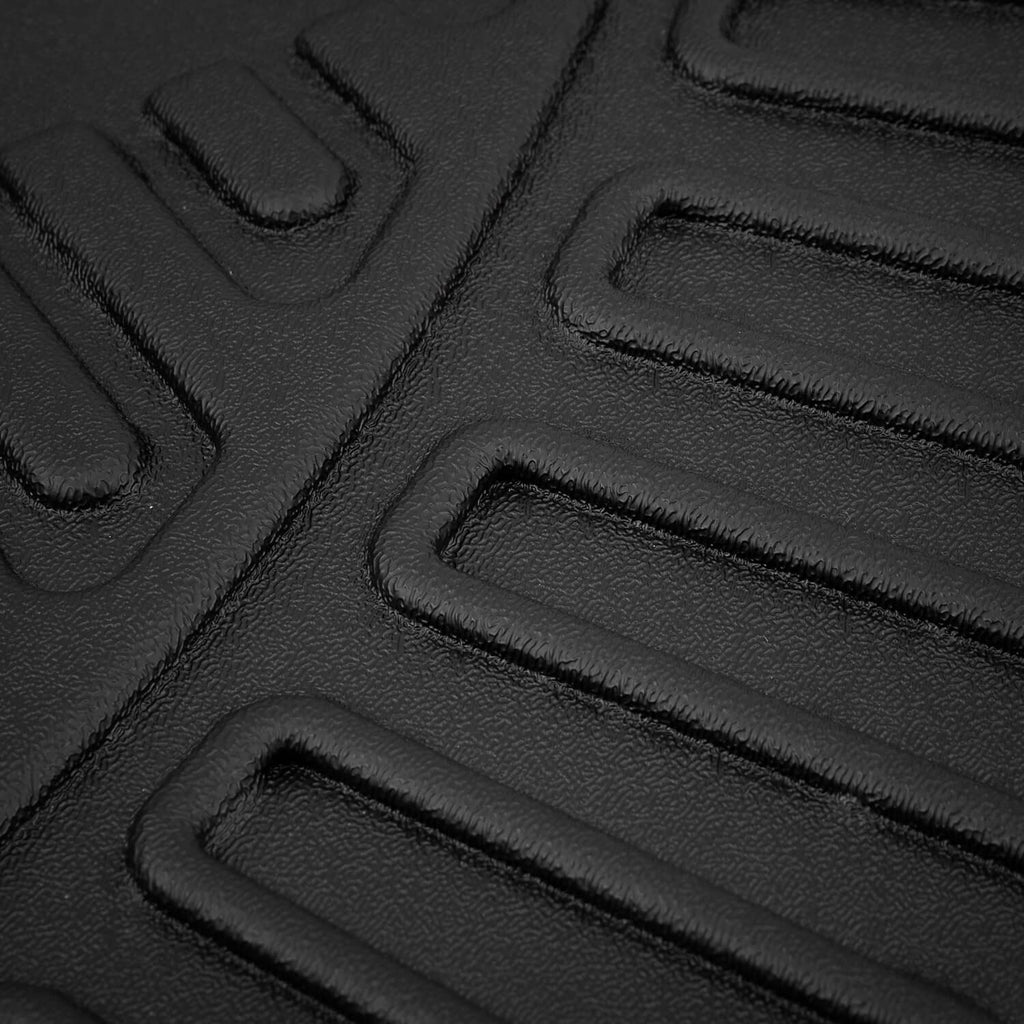 Close-up of black molded floor mat tread texture with raised traction lines
