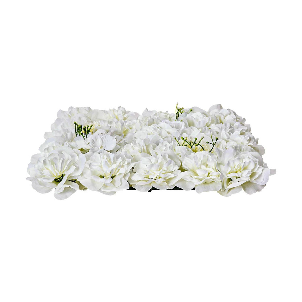 White artificial flower wall panel with layered blossoms and green stem accents