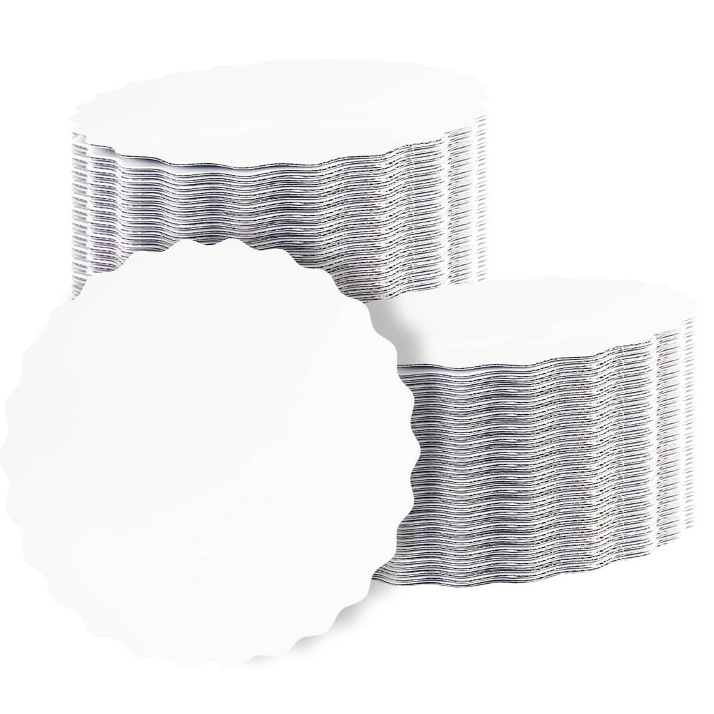 Stack of white round wave cake boards with scalloped edges, 6 in size