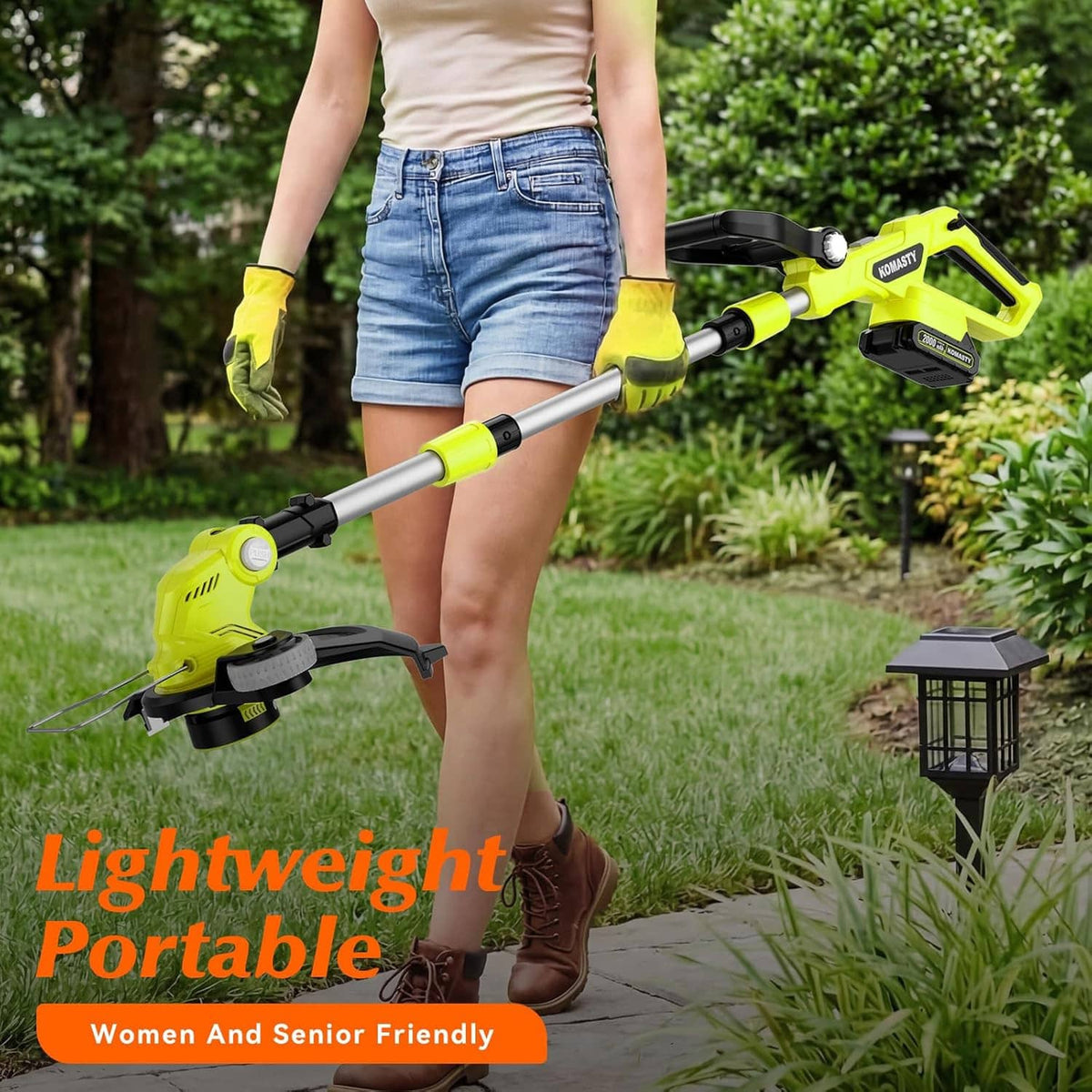 Cordless weed wacker/edger with green handle and long shaft, trimming grass outdoors
