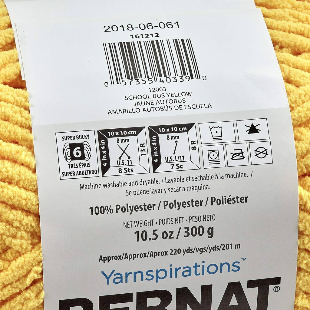 Close-up of the yarn label on yellow chenille blanket yarn skein