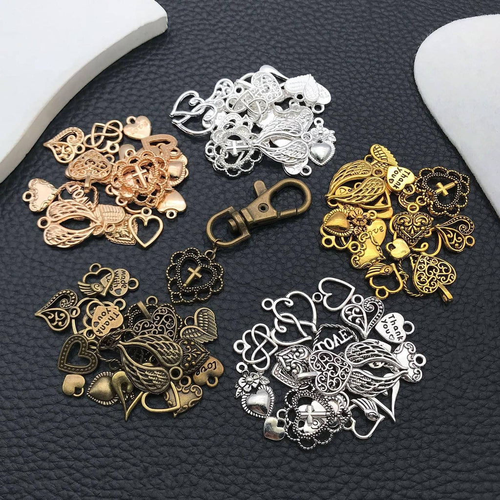 Assorted metal heart and cross charms in gold, silver, and bronze tones; flat lay
