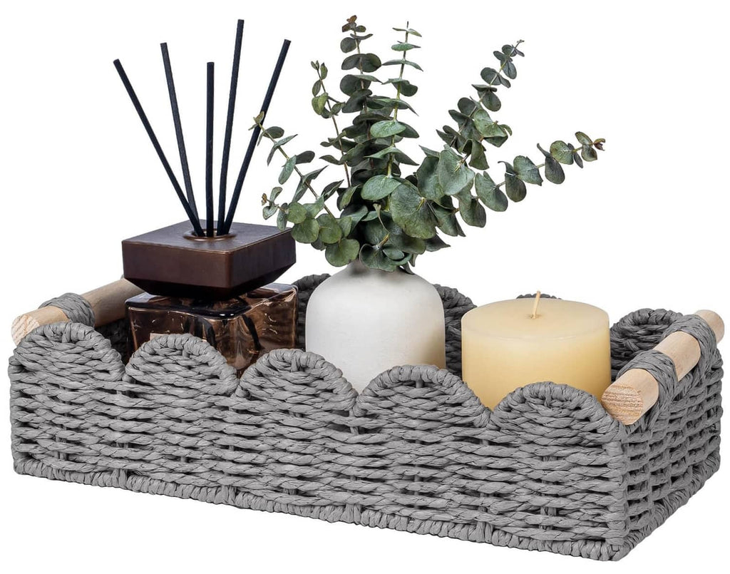 Grey woven toilet paper storage basket with scalloped open top and rope handle accents.
