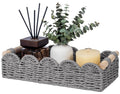 Grey woven toilet paper storage basket with scalloped open top and rope handle accents.