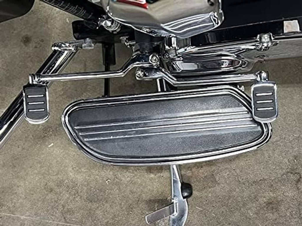Installed chrome heel-toe shift pegs with black rubber foot pads on vehicle