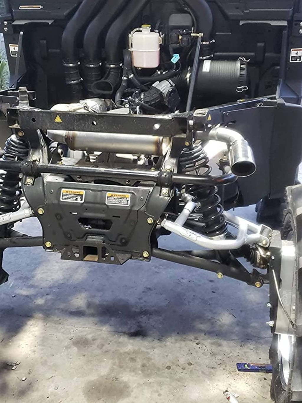 Exhaust muffler assembly with metal inlet/outlet pipes installed on vehicle