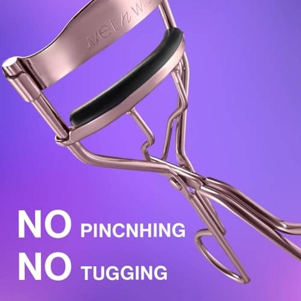 Rose gold eyelash curler with black padded clamp for lifting lashes