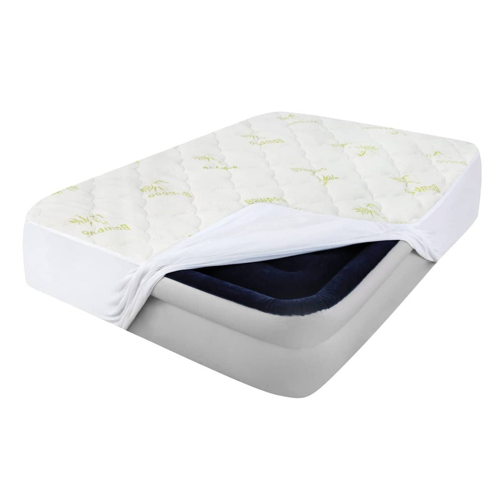 White quilted mattress pad cover with green bamboo print, elastic skirt opening shown