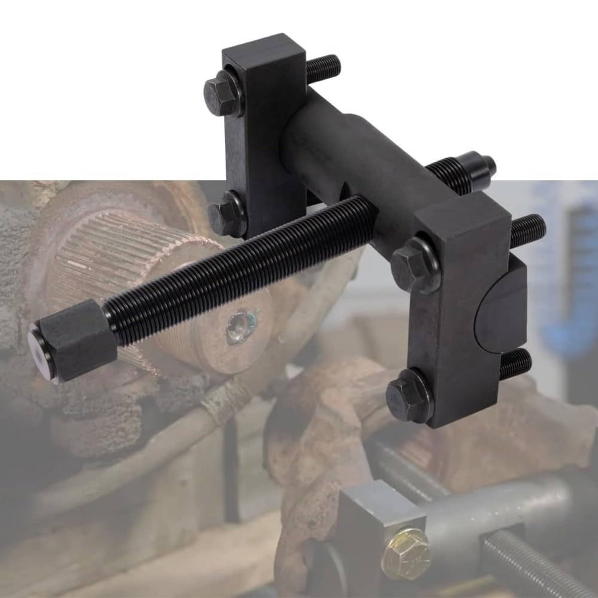 Yoke puller tool clamped to axle hub with long screw pressing against bearing