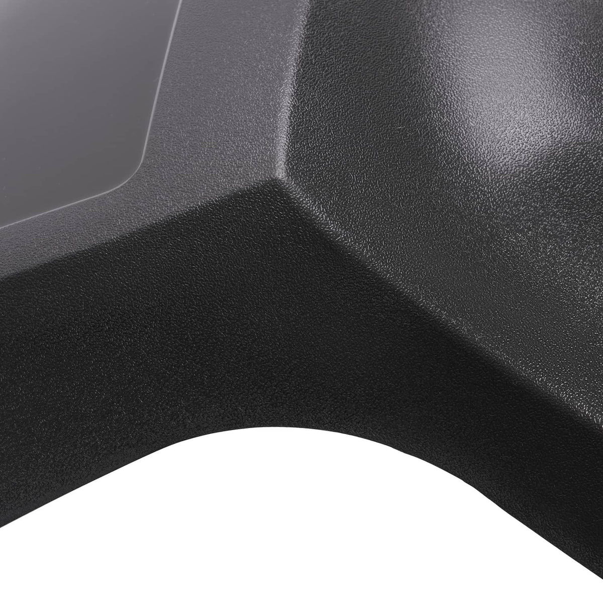 Close-up of dark gray molded air dam cap texture and raised edges