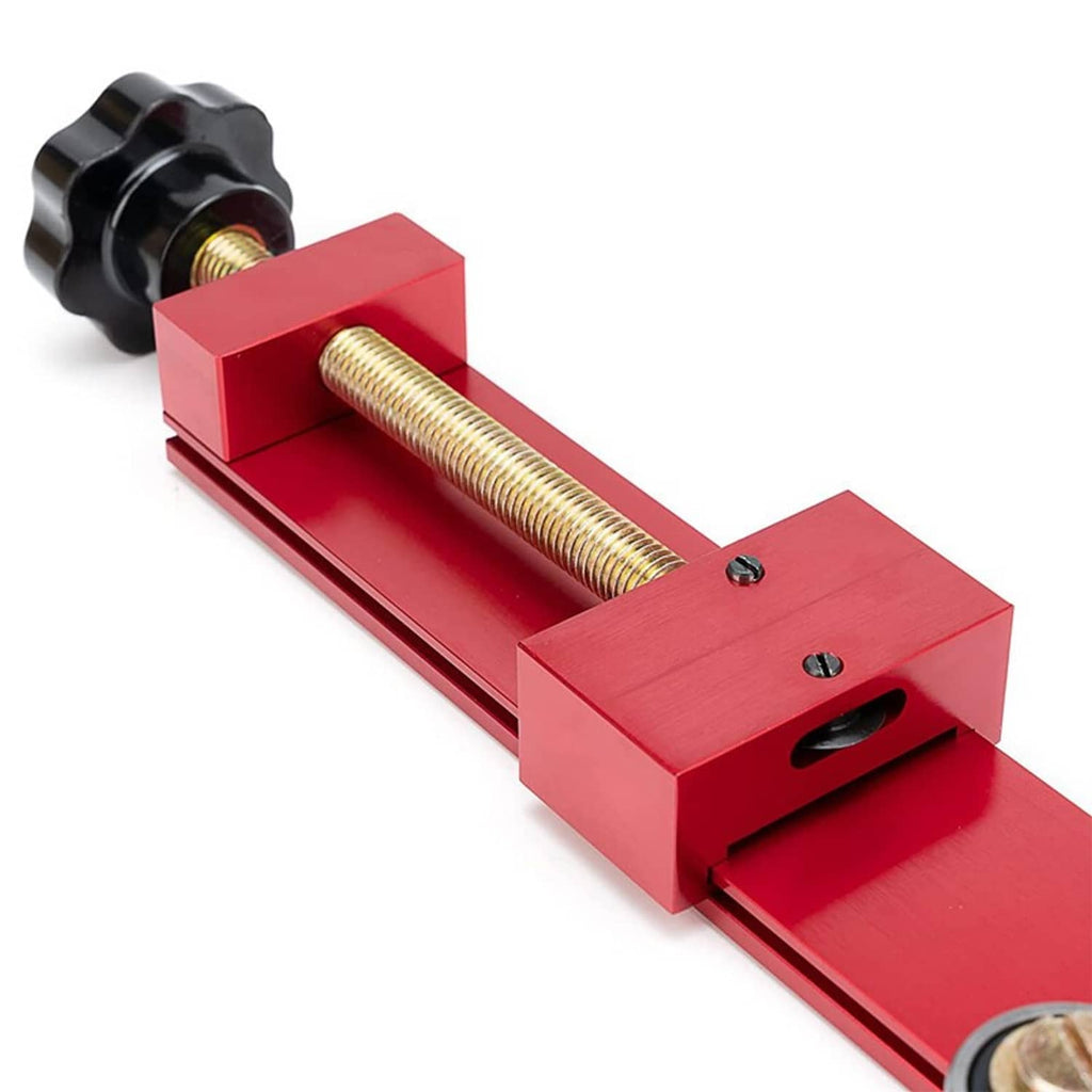 Close-up red oil filter cutter tool with threaded rod, black knob, and mounting slot