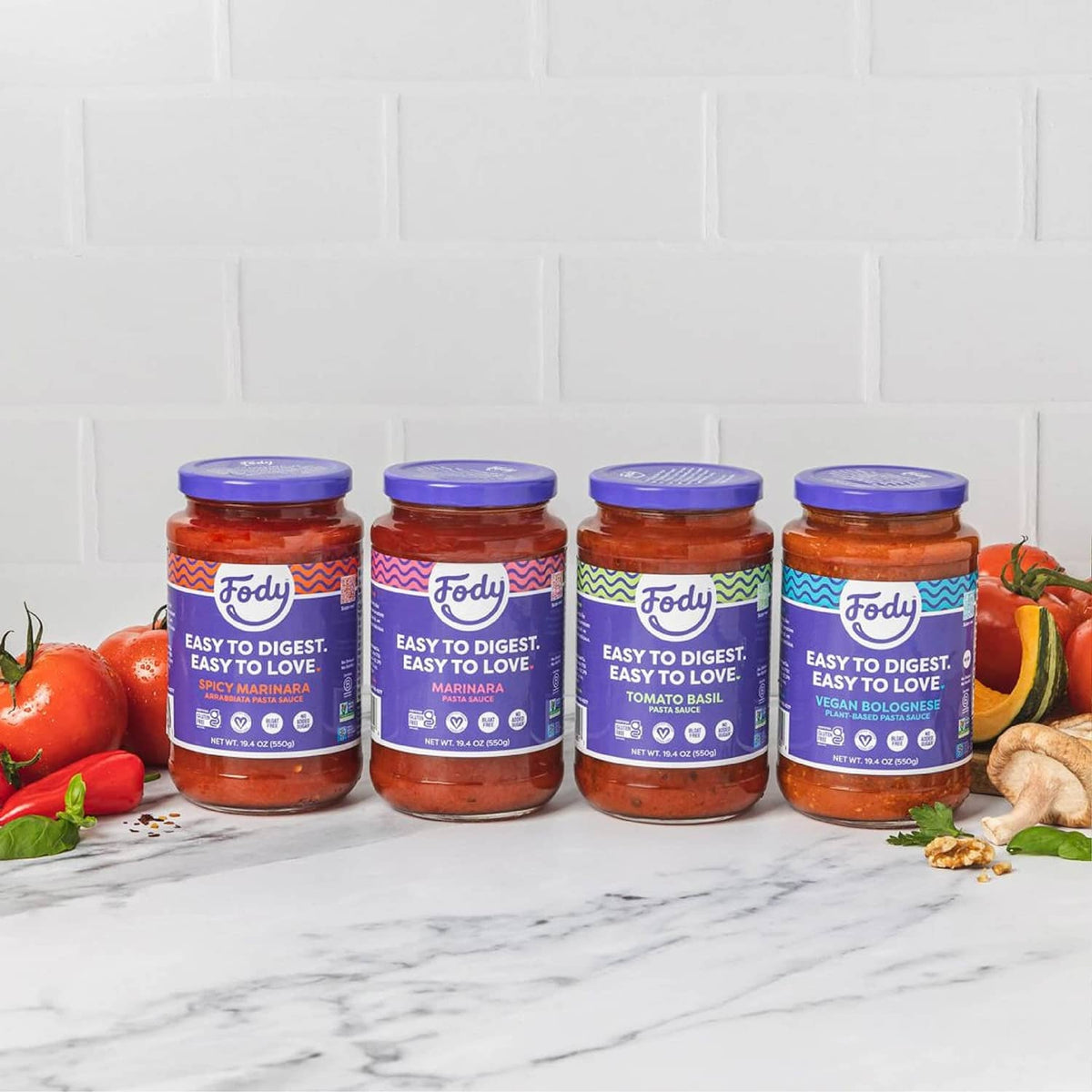 Row of Fody tomato basil pasta sauce jars with purple caps