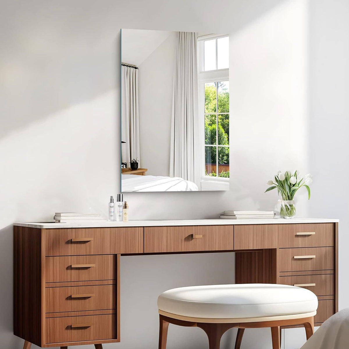 Rectangular frameless mirror mounted above sink with smooth reflective glass