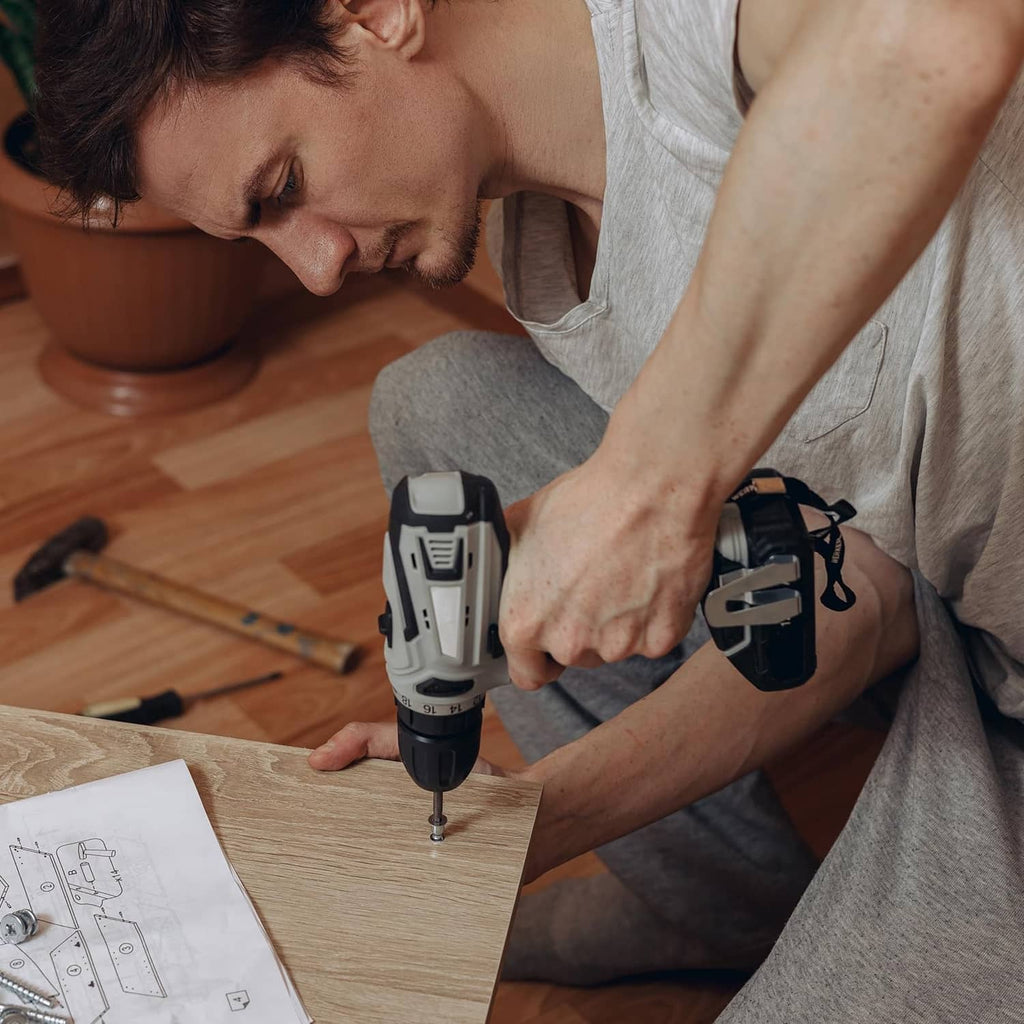 Hand drilling a wooden board with a security Torx bit in a drill driver