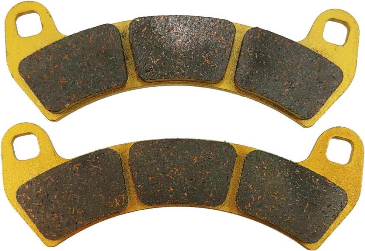 Ceramic brake pads close-up, gray friction segments with speckled surface on gold backing