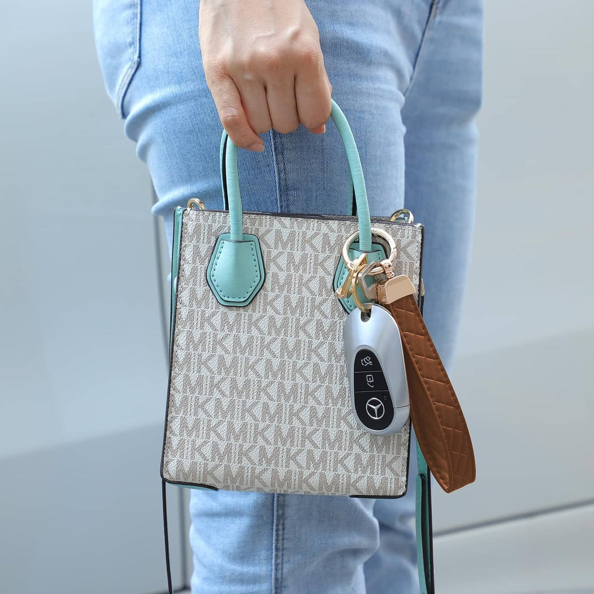 Brown quilted leather wristlet keychain with gold D-ring and attached key fob