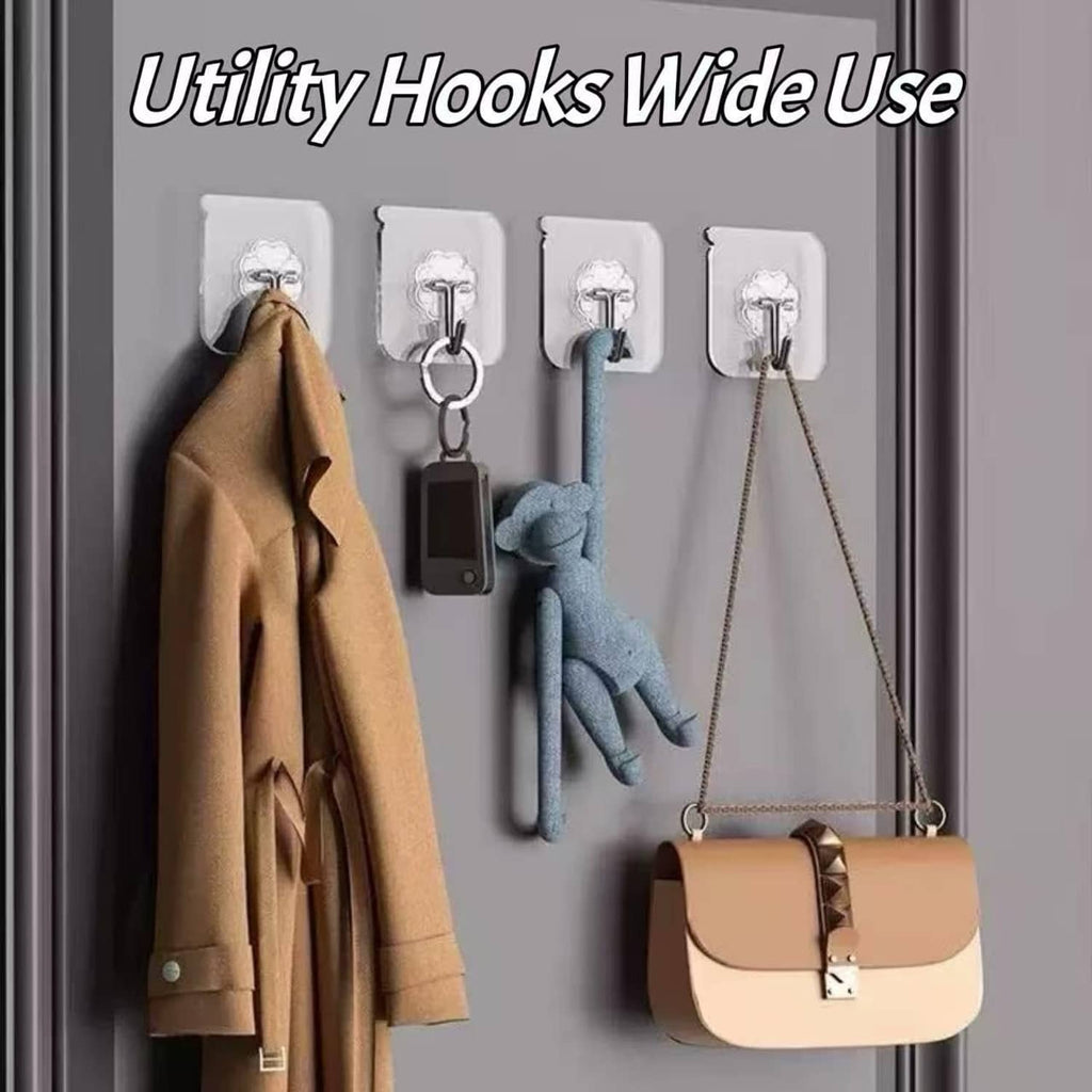 Transparent wall adhesive hooks holding items like coats, keys, and a bag on a door