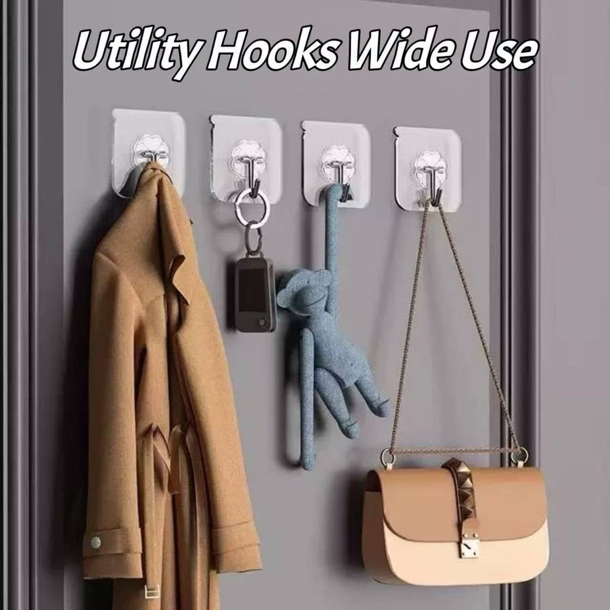 Transparent wall adhesive hooks holding items like coats, keys, and a bag on a door