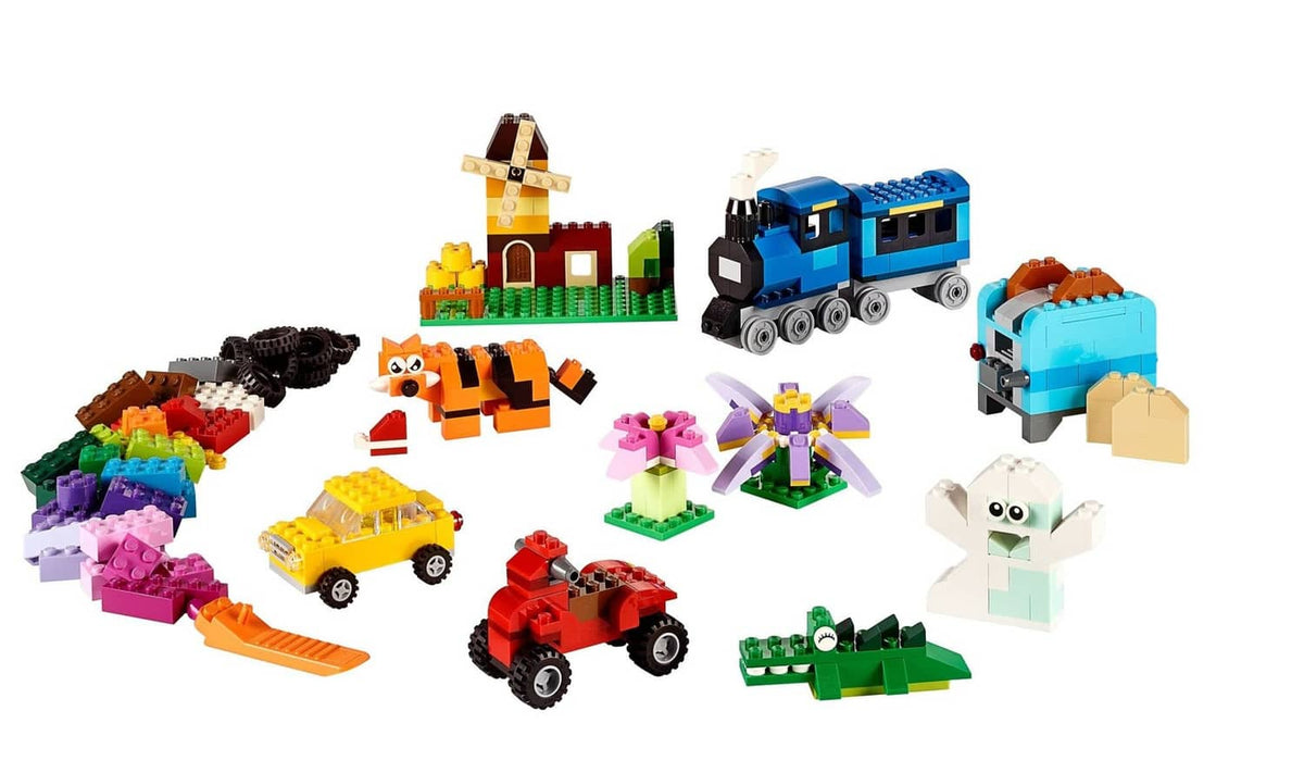 Multicolor LEGO build assortment with house, train, animals, vehicles, and flowers