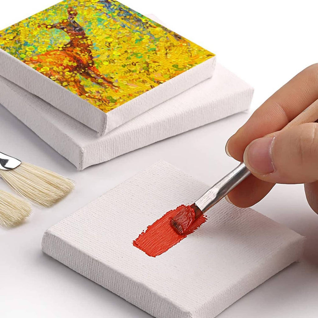 Mini canvas on a small easel while painting with a flat brush