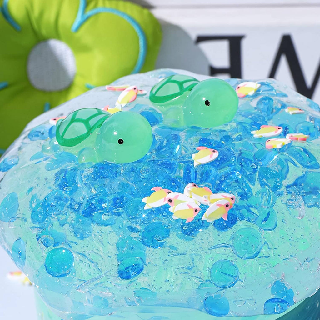 Blue clear slime with two green turtle toys floating on the surface
