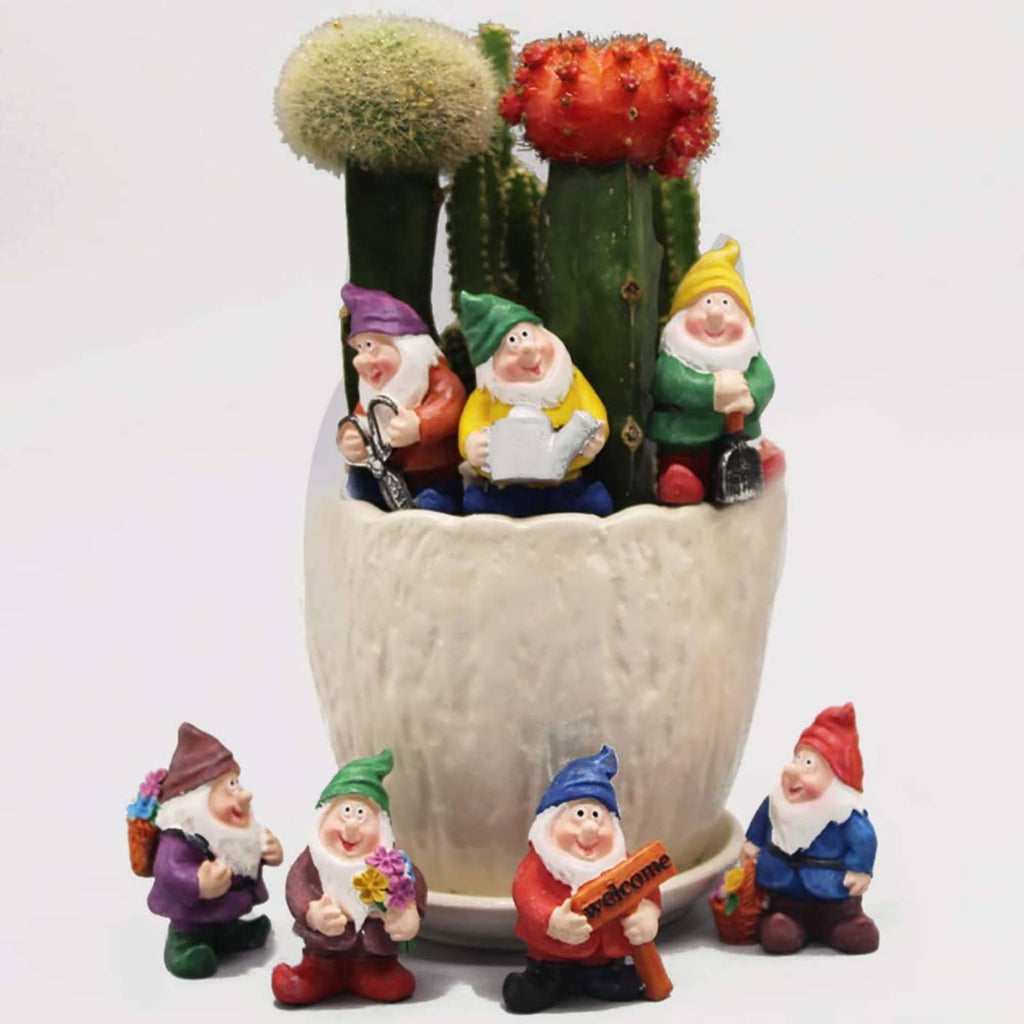 Miniature gnome figurines in a faux planter pot, holding flowers and welcome signs