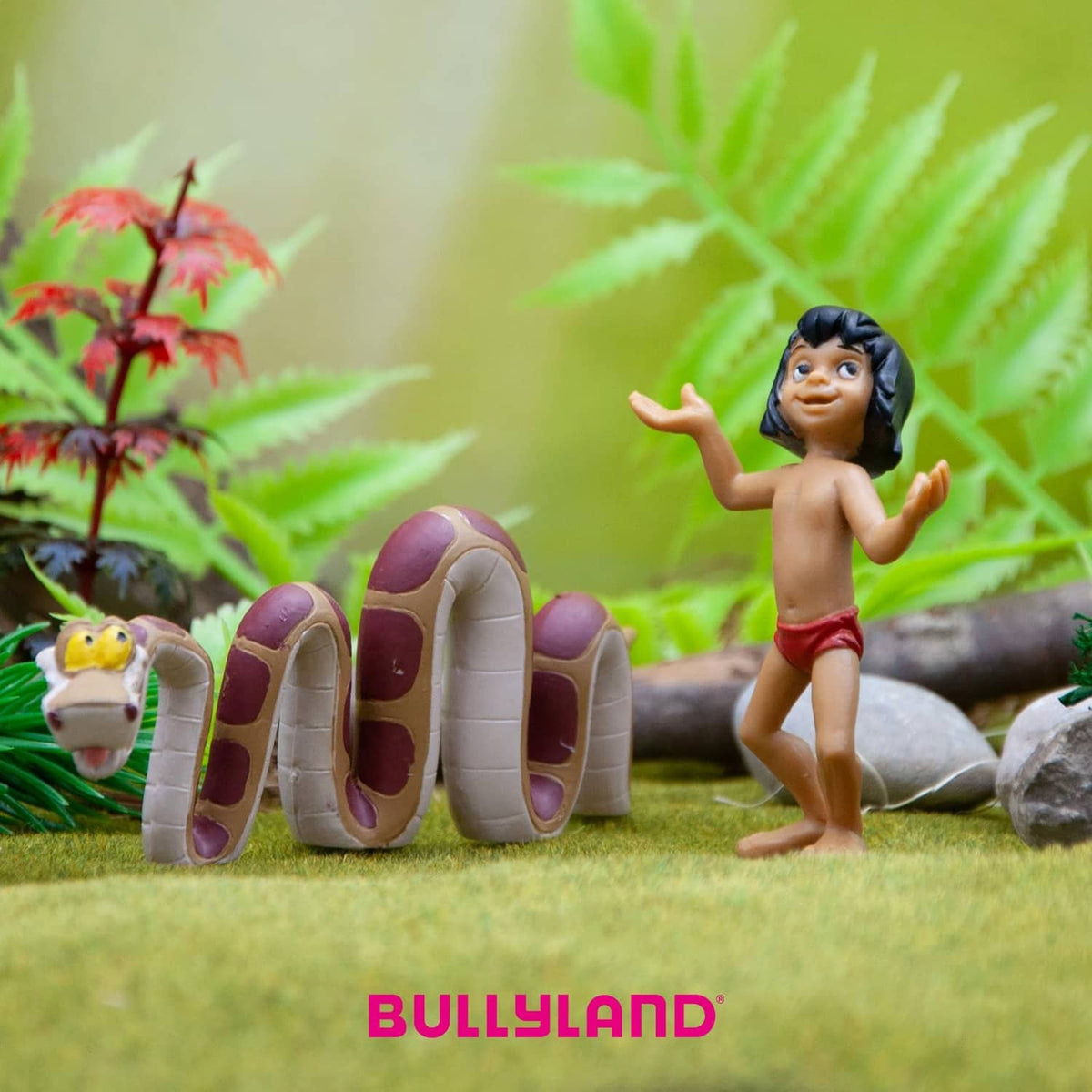 Mowgli hand-painted toy figurine, black hair, red shorts, arms up beside shoes and small animal