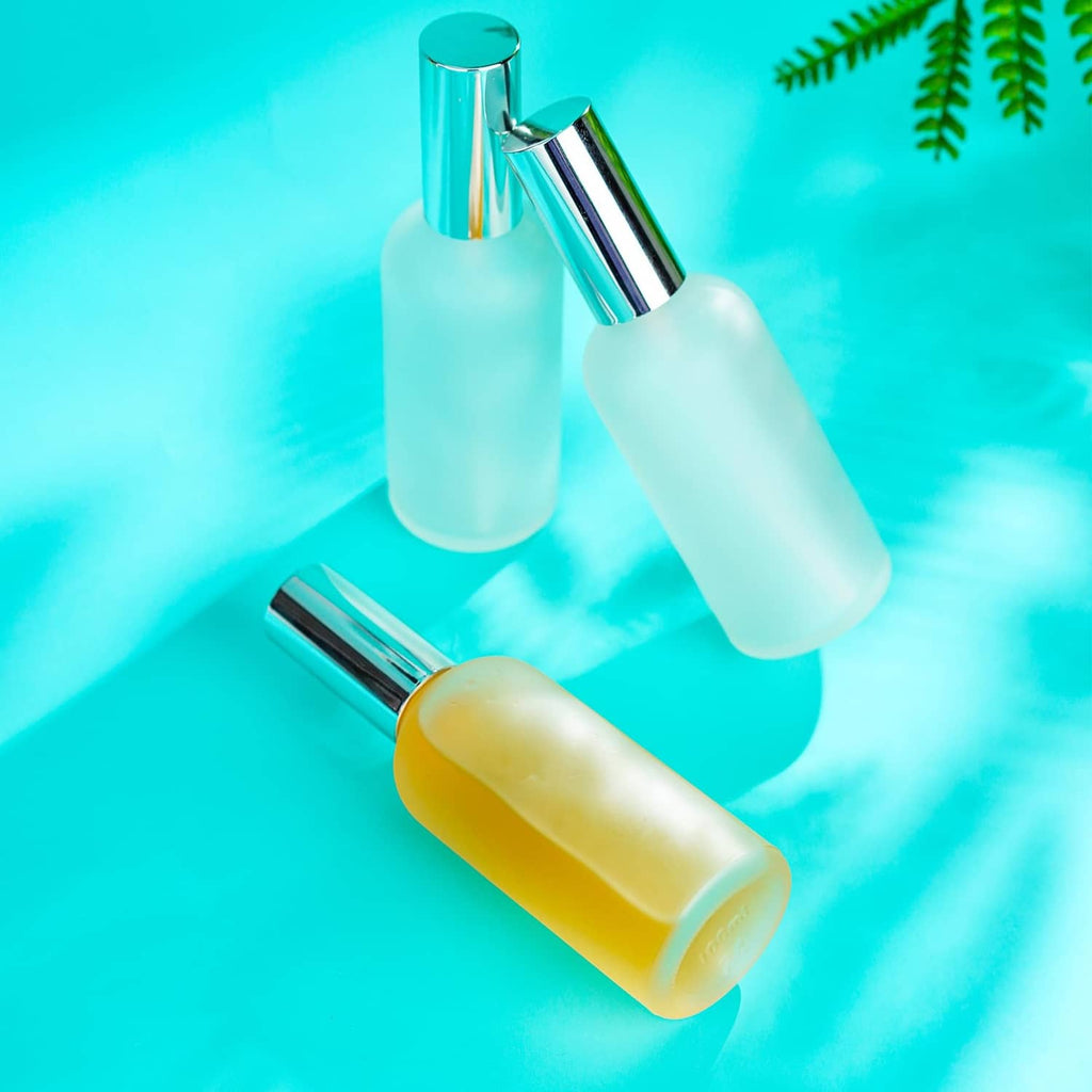 Frosted glass perfume atomizer bottles, light aqua and yellow with chrome caps