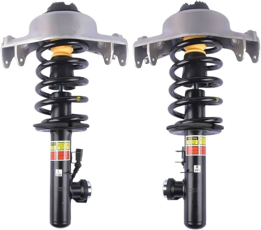 Two electronic shock strut assemblies with black coil springs and labeled shock cylinders
