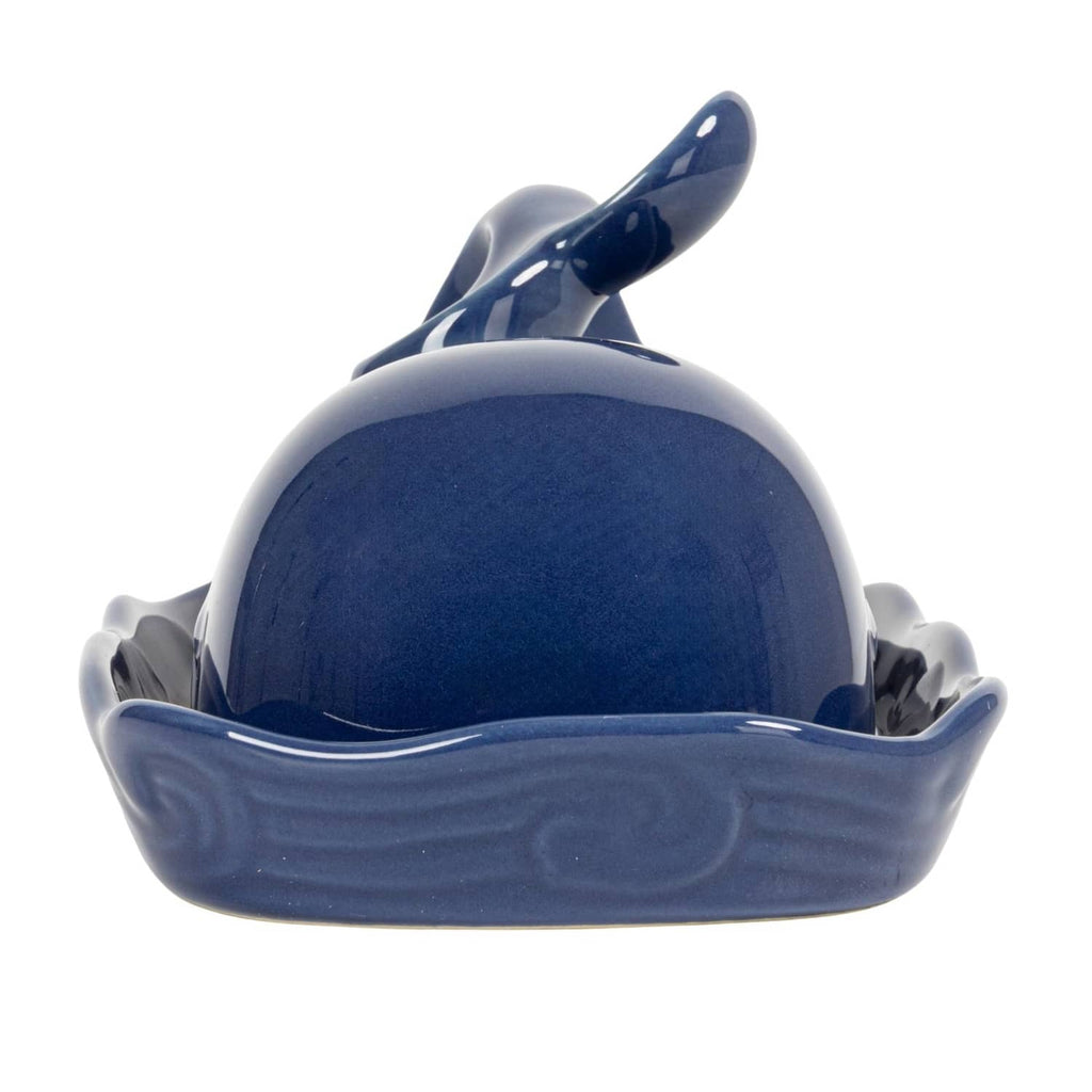 Dark blue whale-shaped butter dish lid on wave-textured tray, rear view