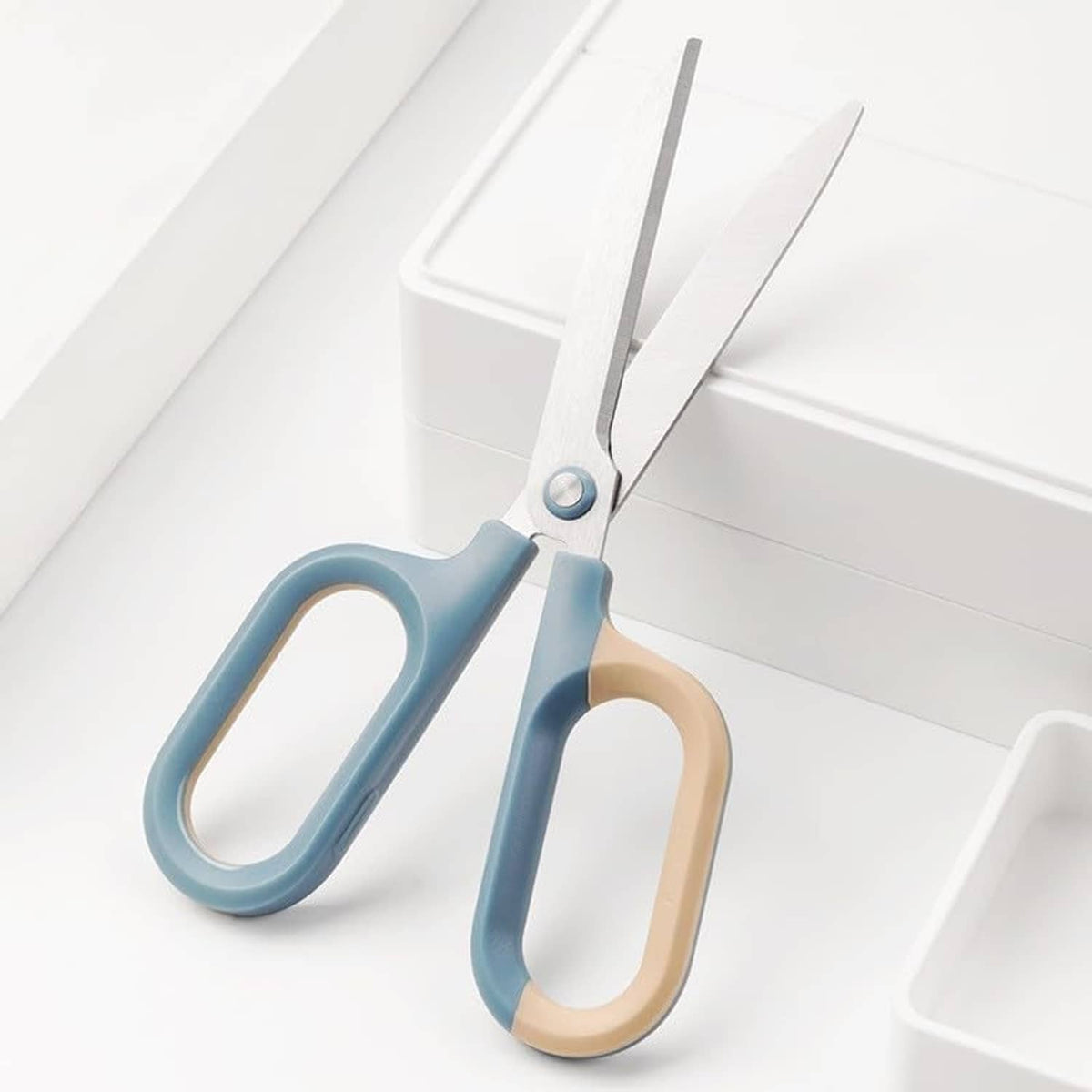 Pair of craft scissors with light blue and beige oval comfort-grip handles