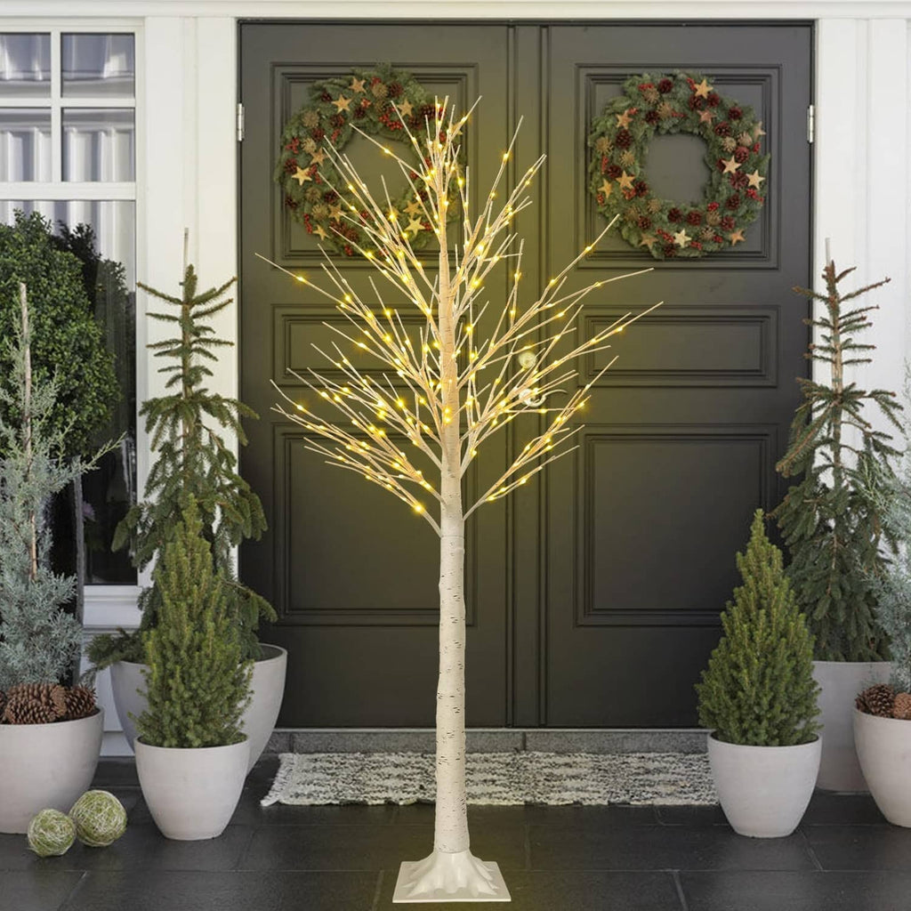 6 ft LED lighted birch tree decoration with warm white lights centered by doorway