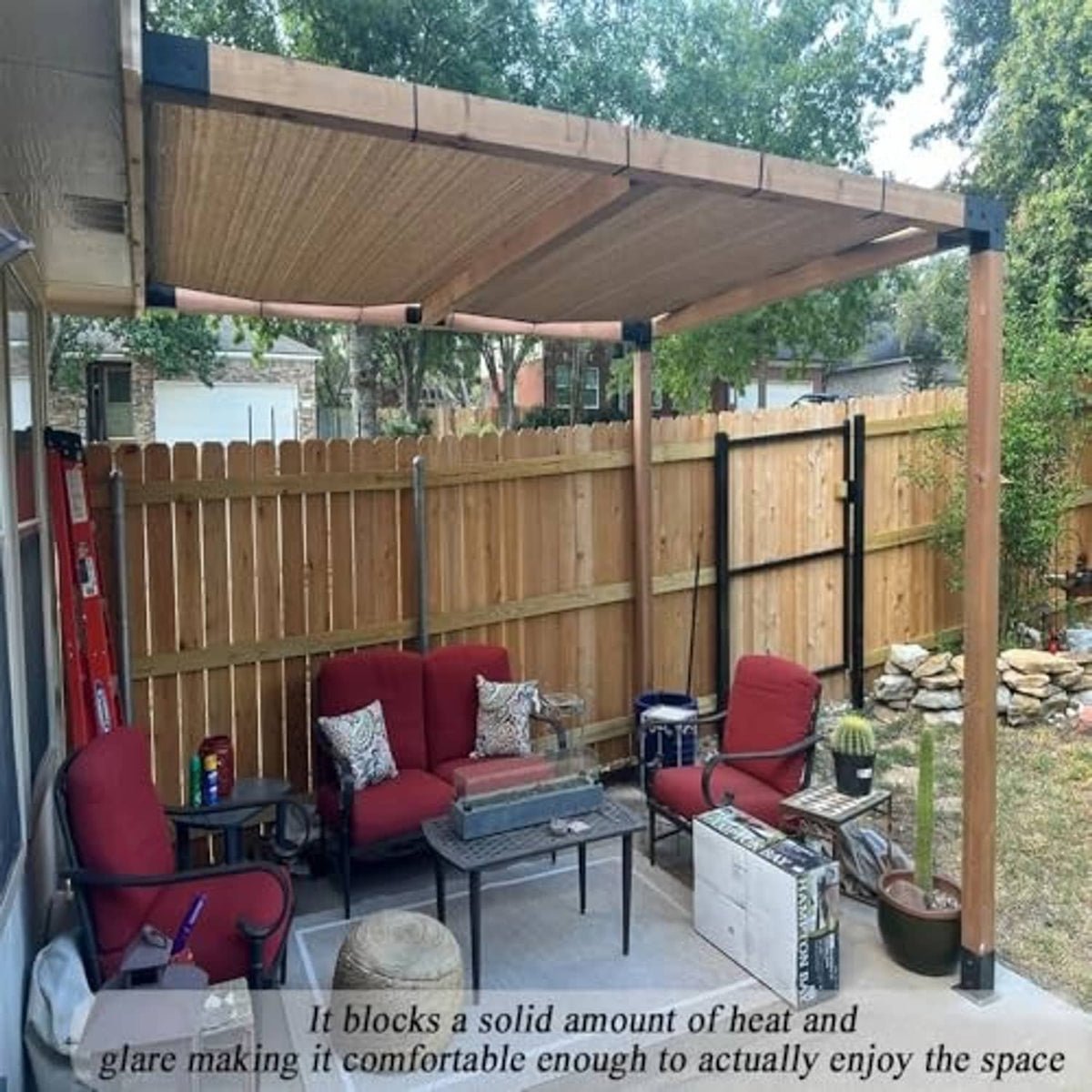 Brown woven shade cloth attached under a backyard pergola for sun shade and privacy