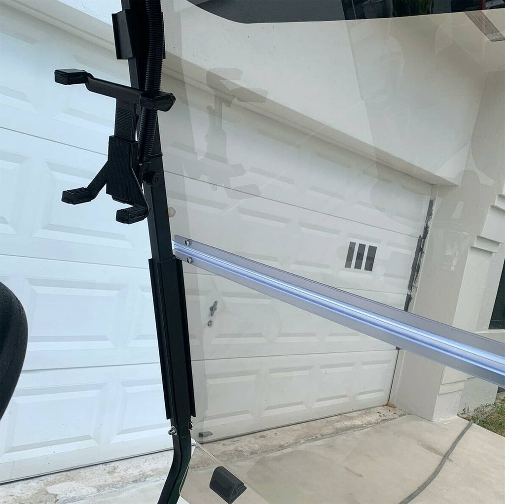 Tinted golf cart windscreen with fold-down black frame and vertical supports