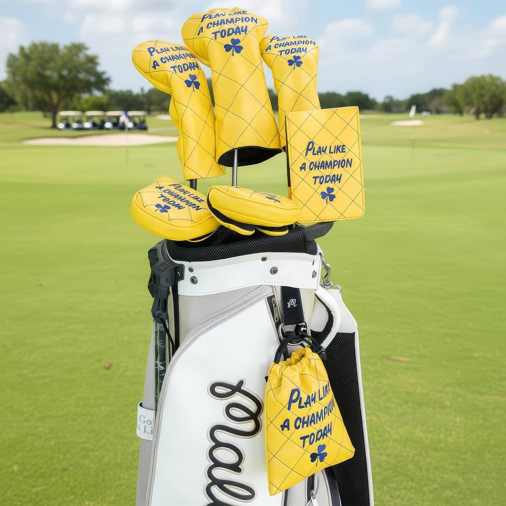 Yellow drawstring pouch with blue "Play Like a Champion Today" print on a golf bag setup.