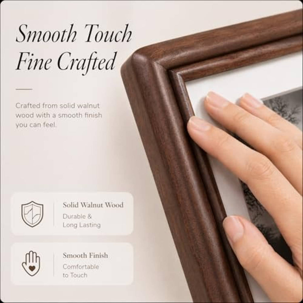 Walnut wood picture frame corner with smooth finish, close-up with a hand