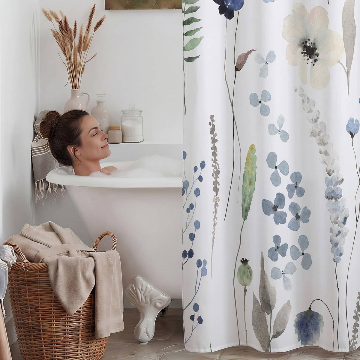 Blue and green floral shower curtain hanging from a rod, full-length view