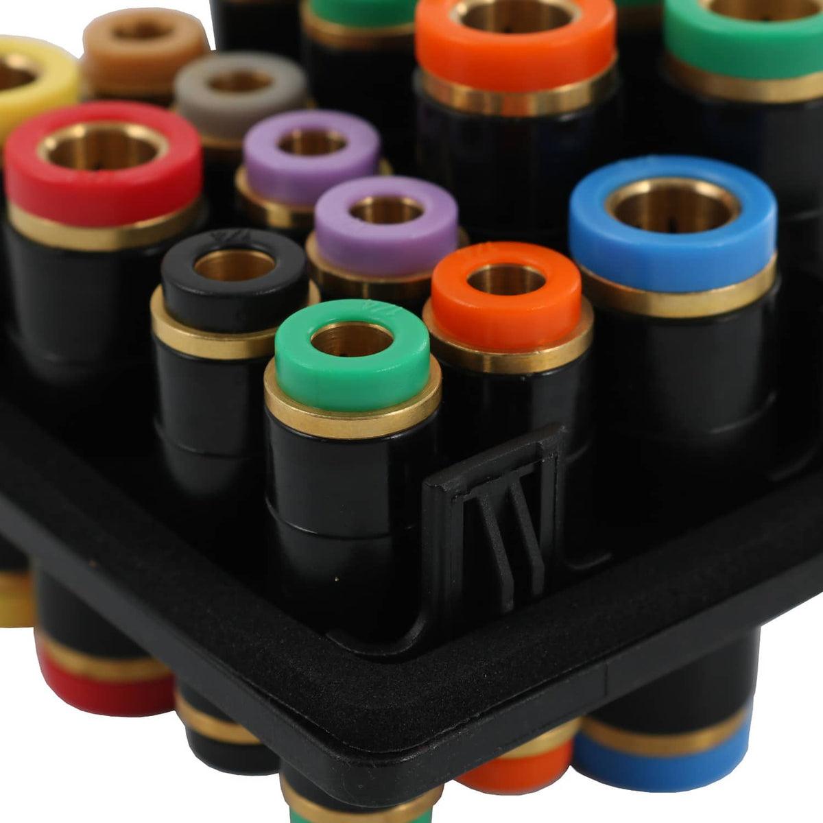 Close-up of black air manifold showing colored rings and brass inner bores