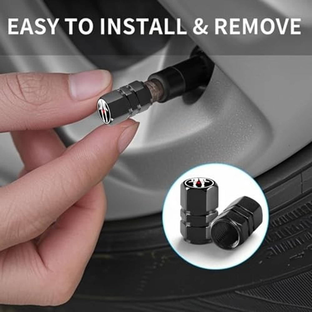Hand installing a black tire valve cap with red flame emblem on a car tire valve.