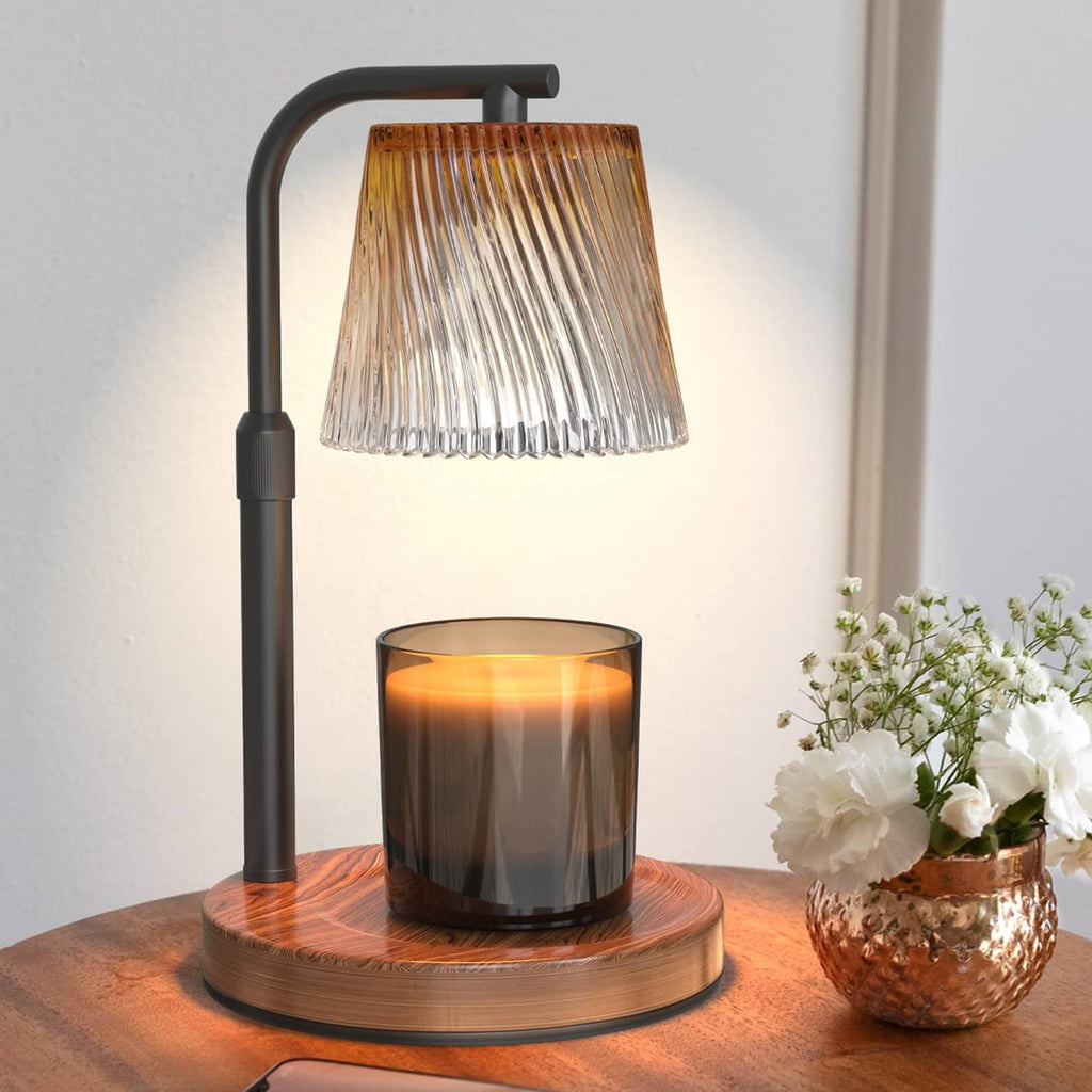 Wood base candle warmer lamp with matte black stand, ribbed glass shade, lit candle